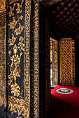 Wat Xieng Thong temple in Luang Prabang, Laos. The sim s interior is extensively decorated with intricate gold stencilling on black lacquer. 